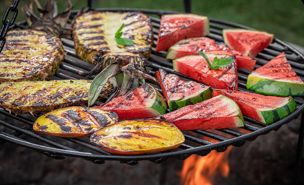 Mango, watermelon and pineapple on a grill