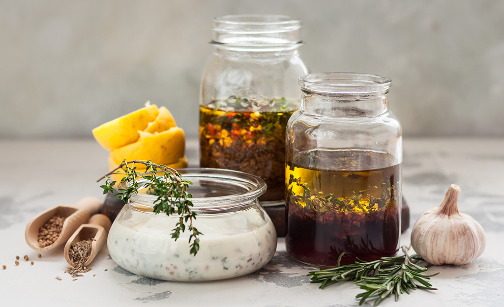 Three jars with herbs and marinades