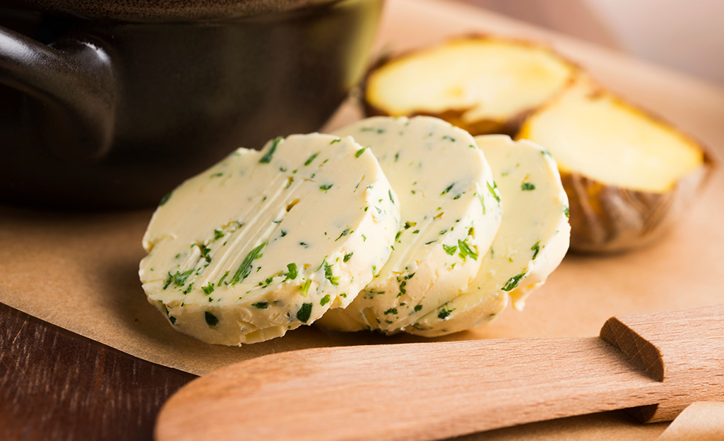 Pats of herb butter on a plate