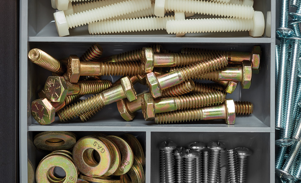 An assortment of nuts and bolts in different finishes and materials.