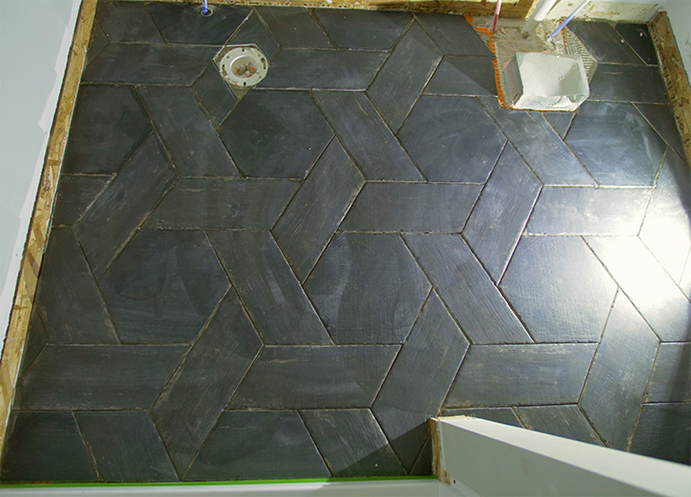 Black floor tile in a basket weave pattern.