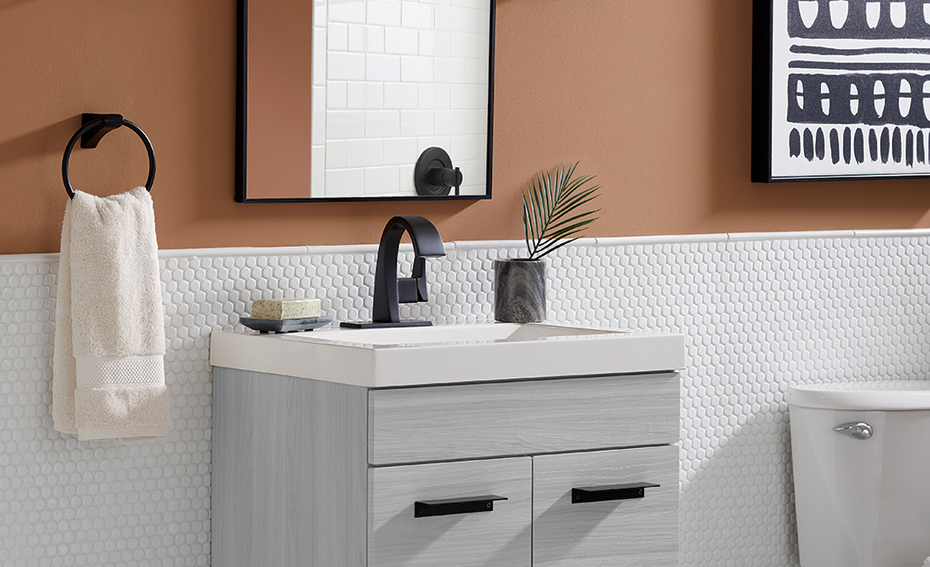 A bathroom vanity with a sleek modern faucet and hardware.