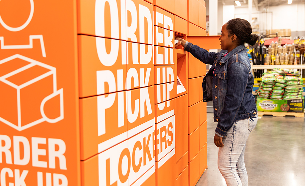 A woman uses in-store lockers to pickup her purchases.