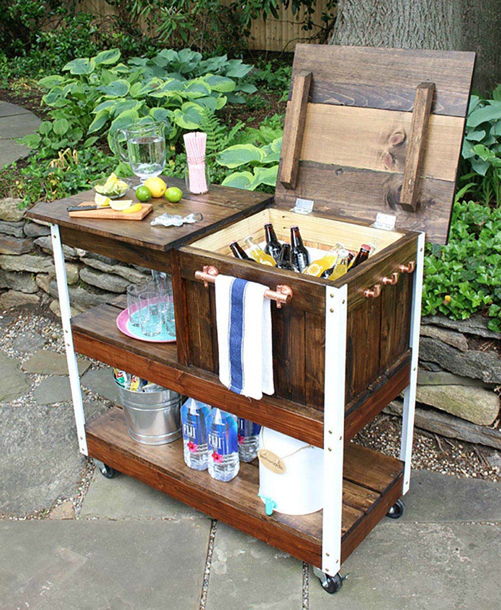 A DIY grill cart with a cooler holder and cutting board area.