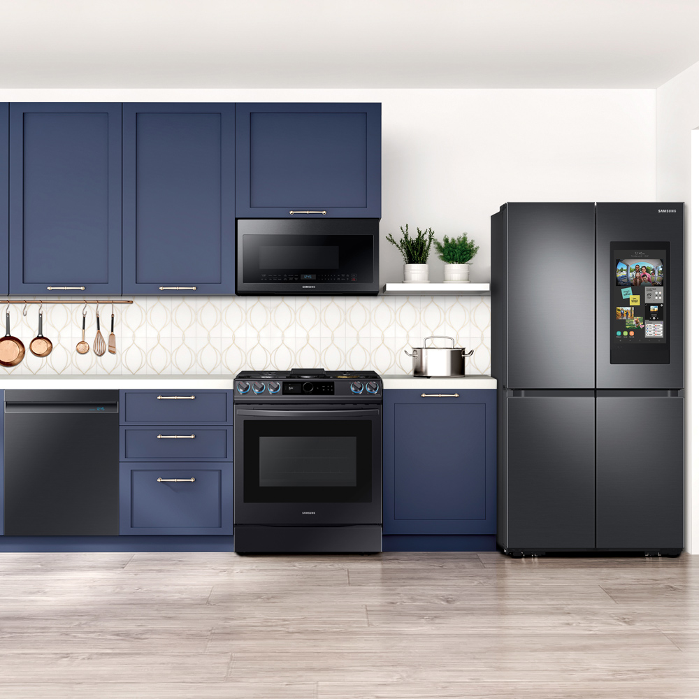 A kitchen with blue cabinets and black appliances.
