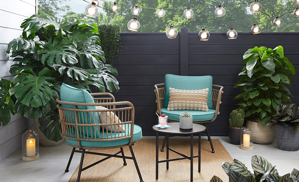 String lights are installed above outdoor chairs on a patio.