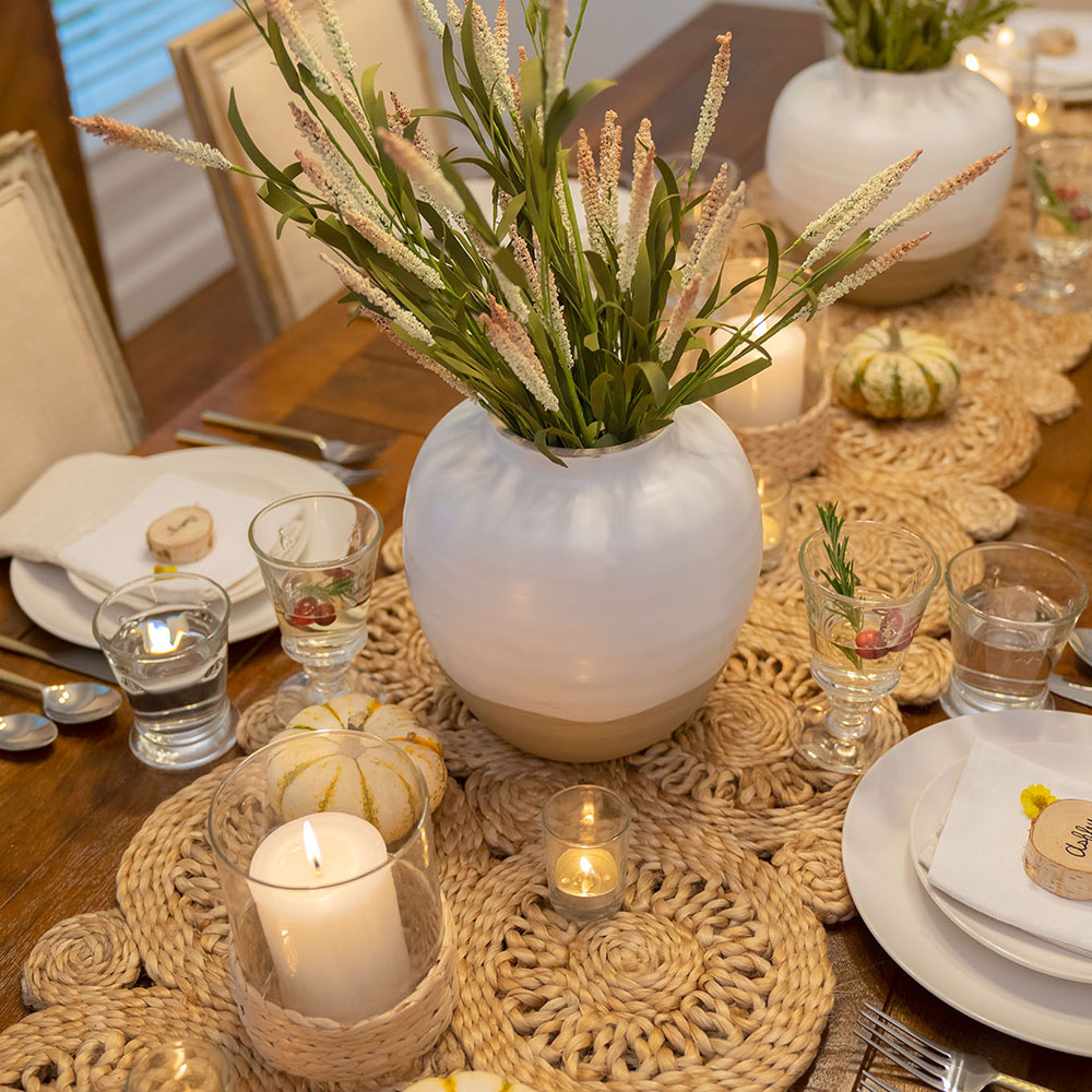 A Friendsgiving table dressed with white and gold details.