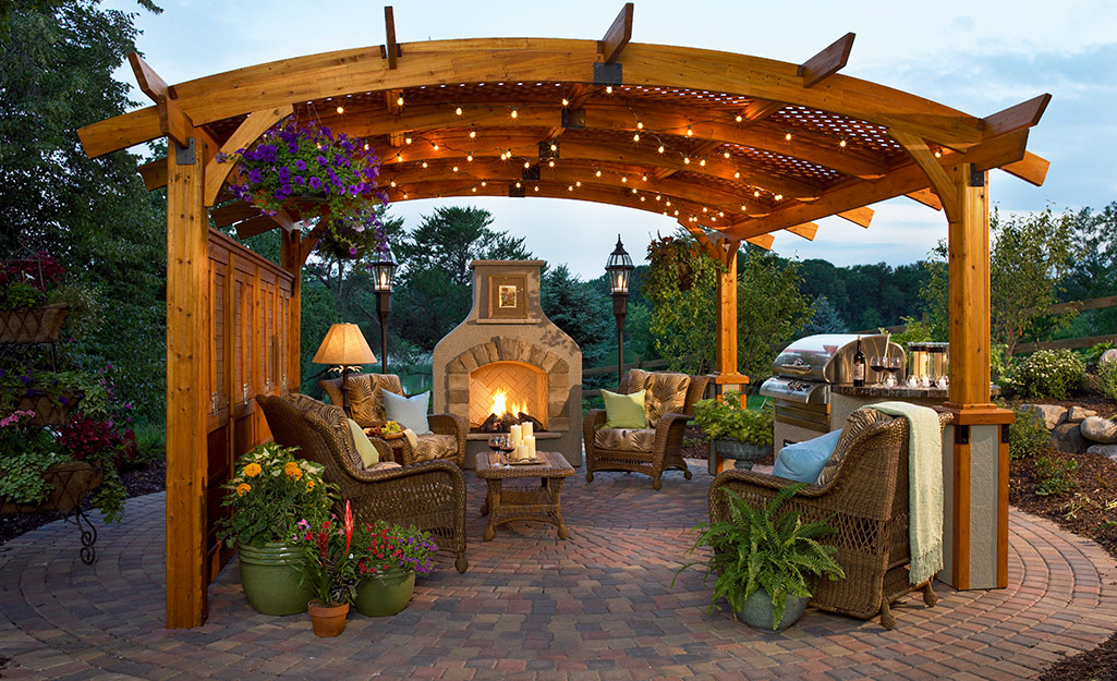 Outdoor seating and a fire pit under a pergola.