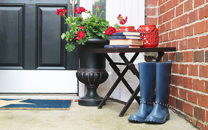 Blue boots, red lantern and red geraniums