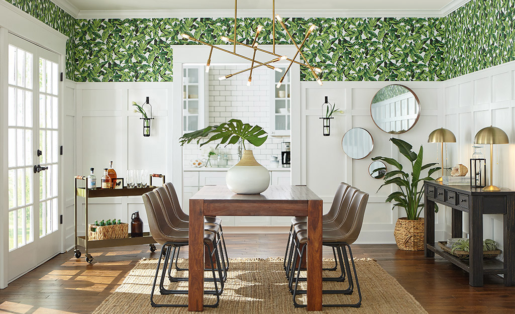 A monstera plant on a dining room table. 