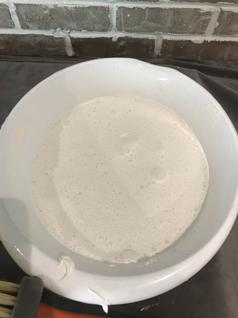 A bucket of limewash mixed with water.