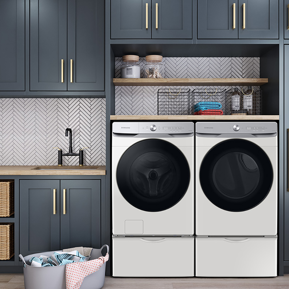 A laundry room with modern appliances and cabinetry.