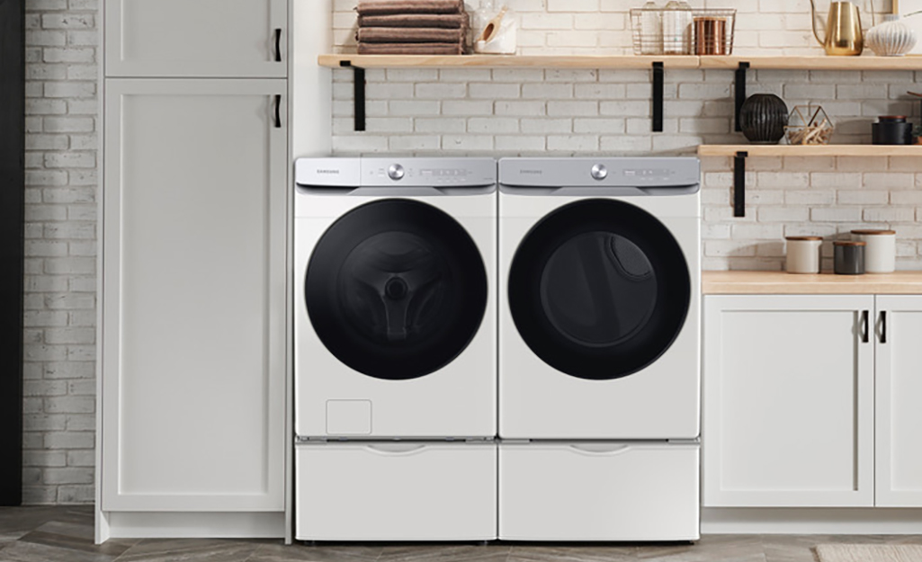 A modern white washing machine and dryer pair.