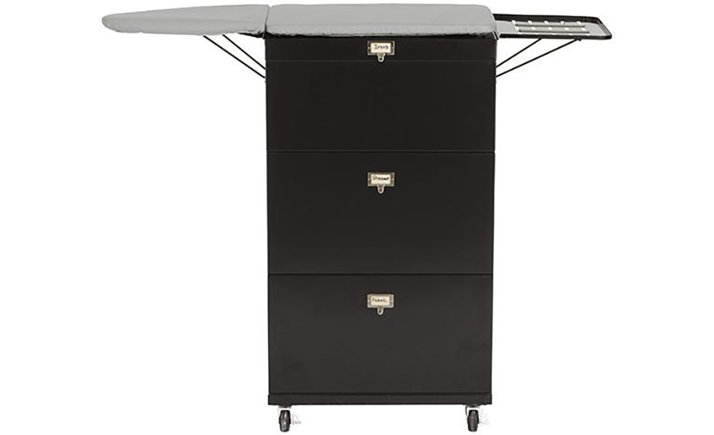 An ironing cart with black cabinets.