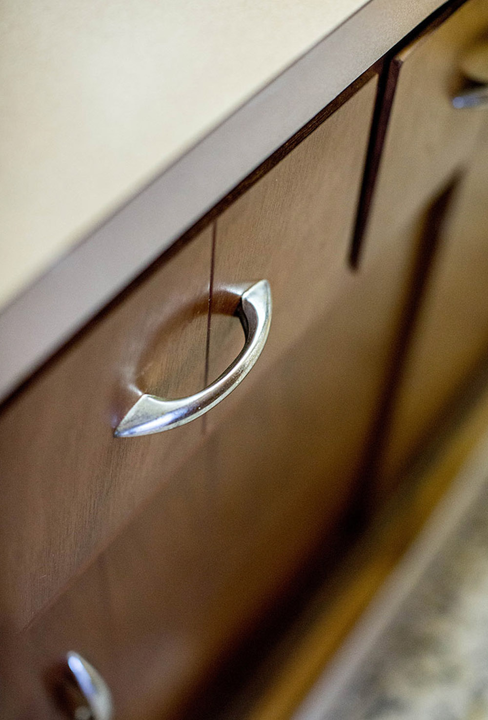 A brown drawer with a silver handle. 