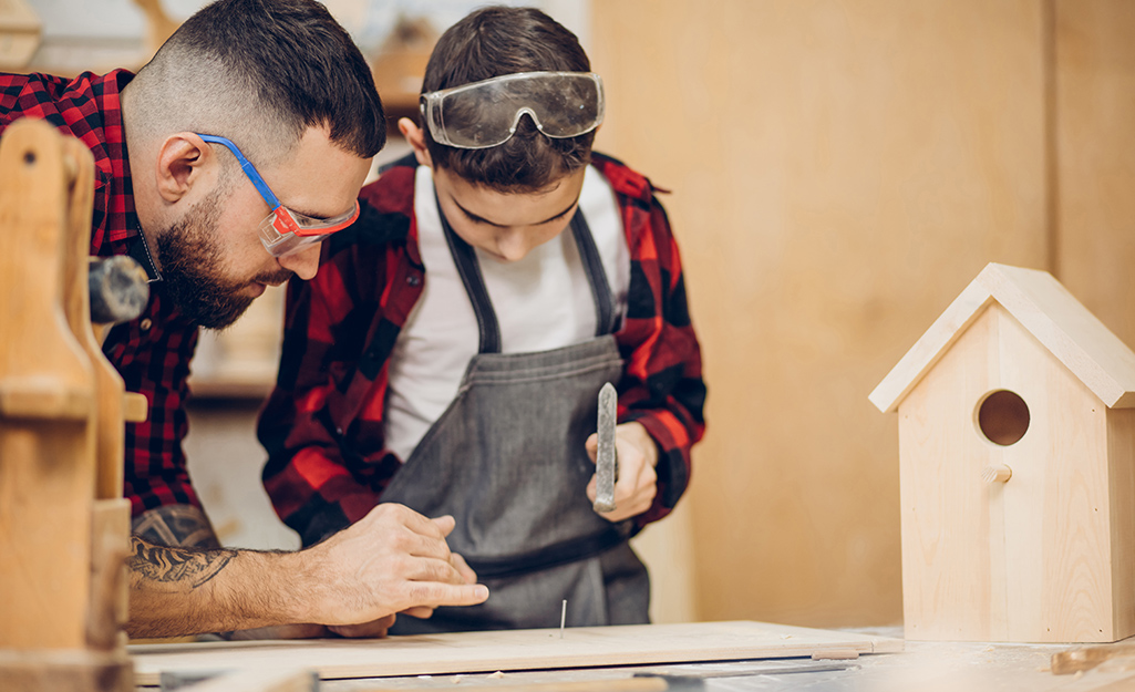 Man and kid building a bird planter for Mother's Day gift.