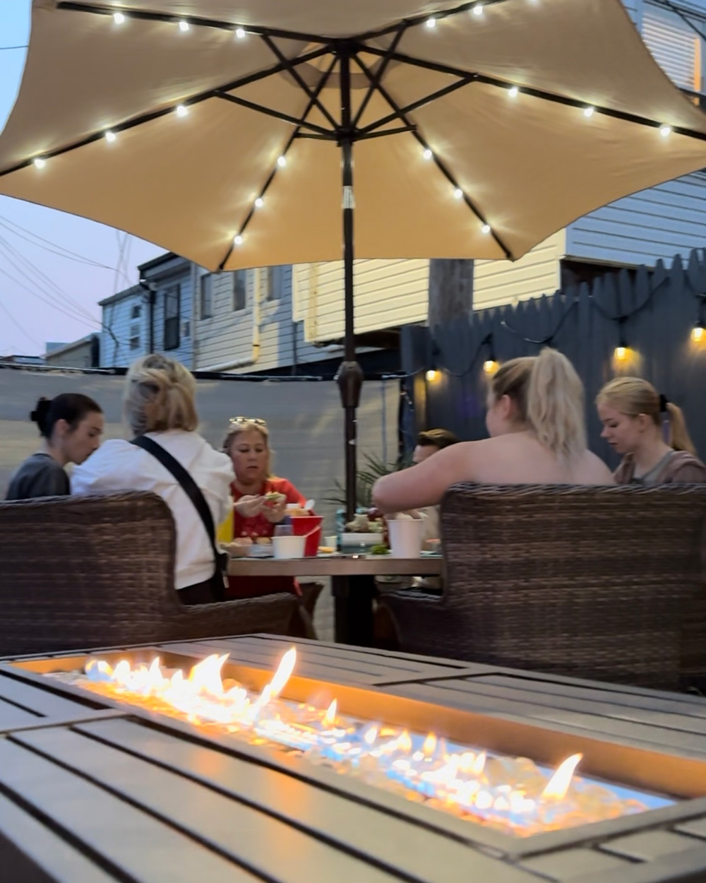 A group enjoying the new lights and fire pit. A group enjoying the new lights and fire pit.