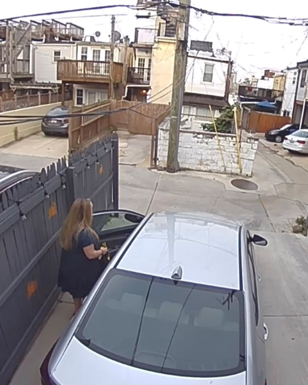 A person is getting into their car. A person is getting into their car.