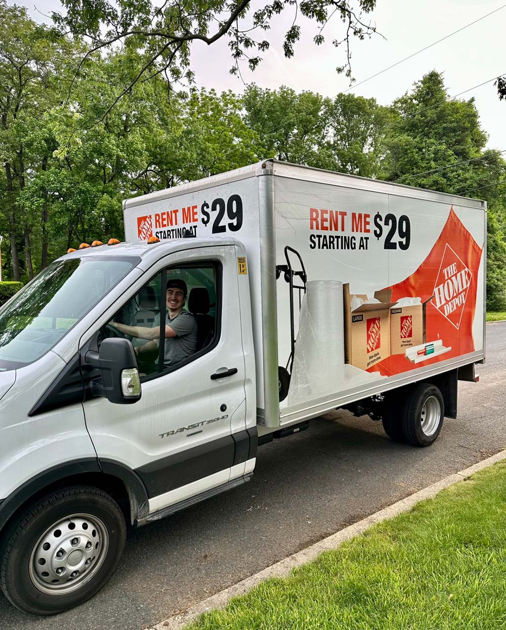 A person driving a Home Depot rental vehicle. A person driving a Home Depot rental vehicle.