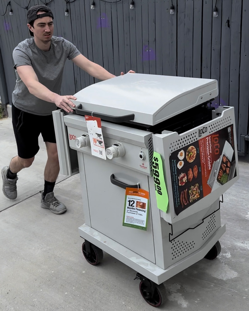 A person pushing a griddle grill. A person pushing a griddle grill.