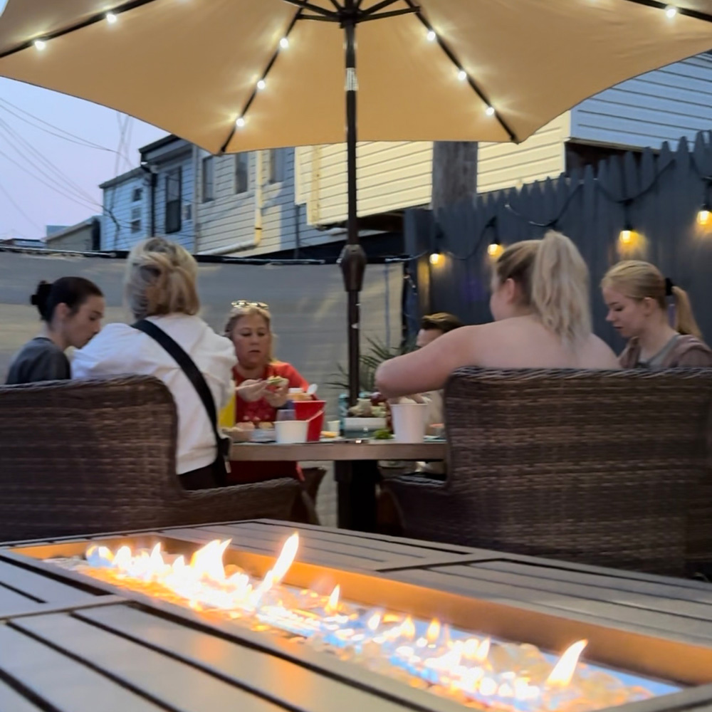 A group enjoying the new lights and fire pit. A group enjoying the new lights and fire pit.