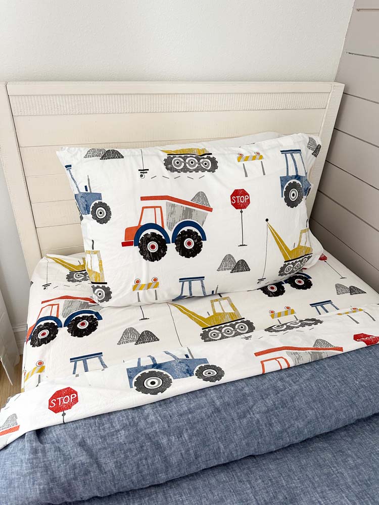 construction and cars themed twin bedding with a grey duvet.