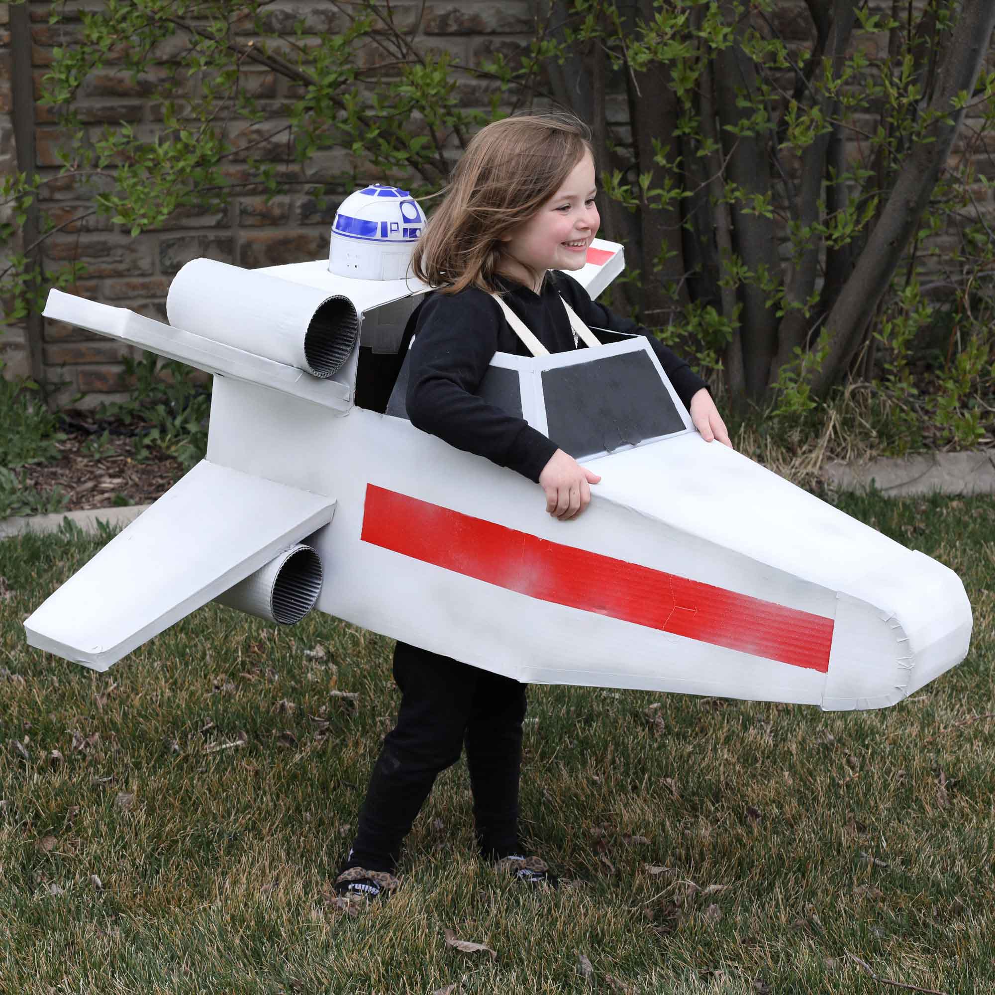 kid in fighter pilot box costume