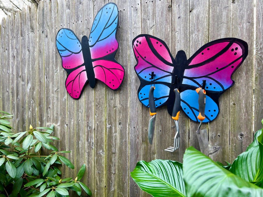 Right angle of painted butterflies on a wooden fence. 