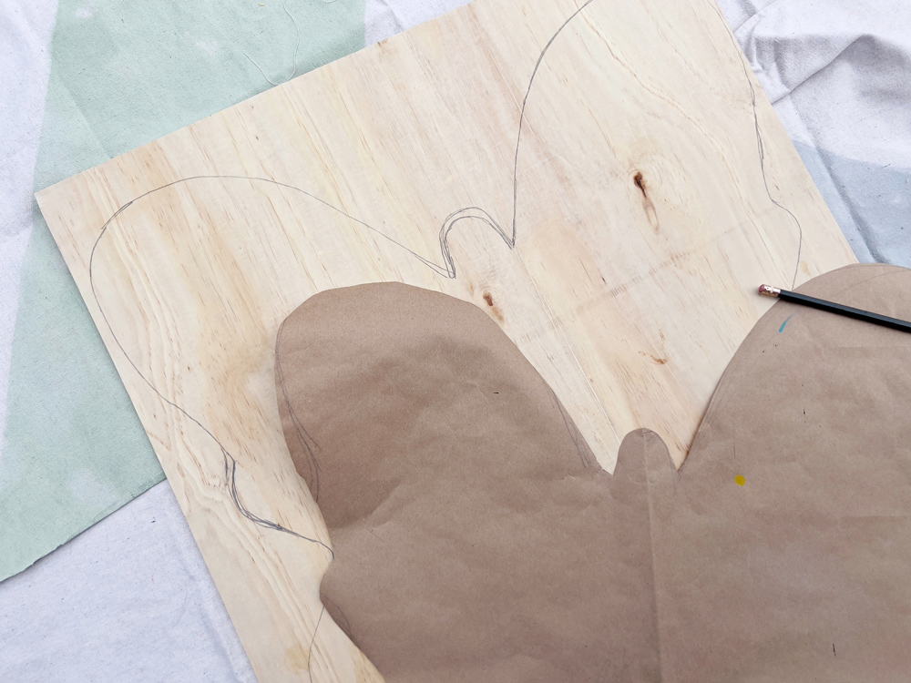 Outline of a butterfly on the plywood sheet.