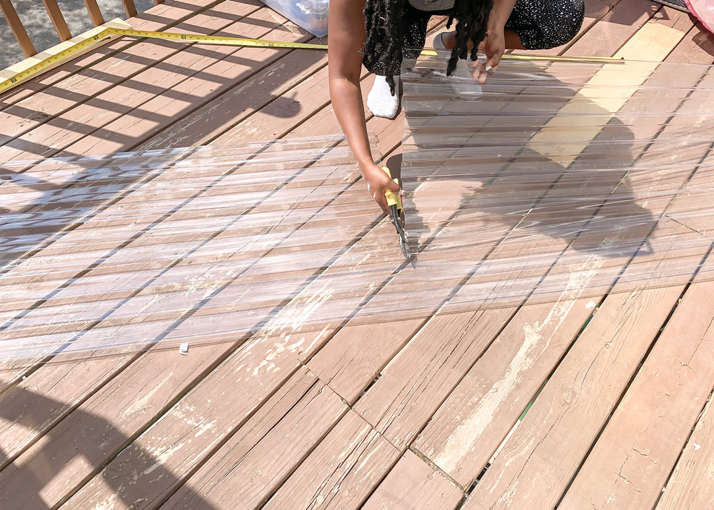 Shot of Ashleigh cutting polycarbonate roofing panel