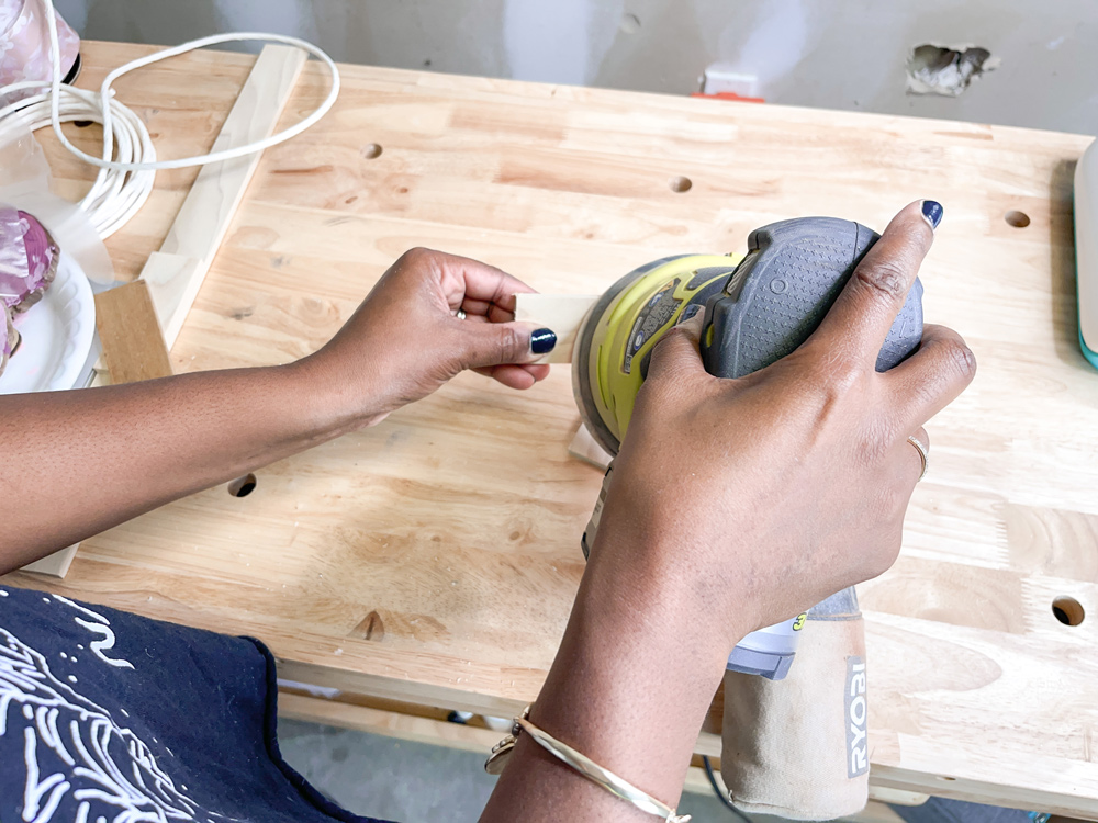 A womanÕs hands using an orbital sander to sand a small piece of wood A womanÕs hands using an orbital sander to sand a small piece of wood
