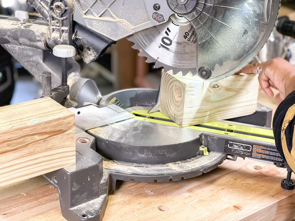 A circular blade saw cutting a block of wood