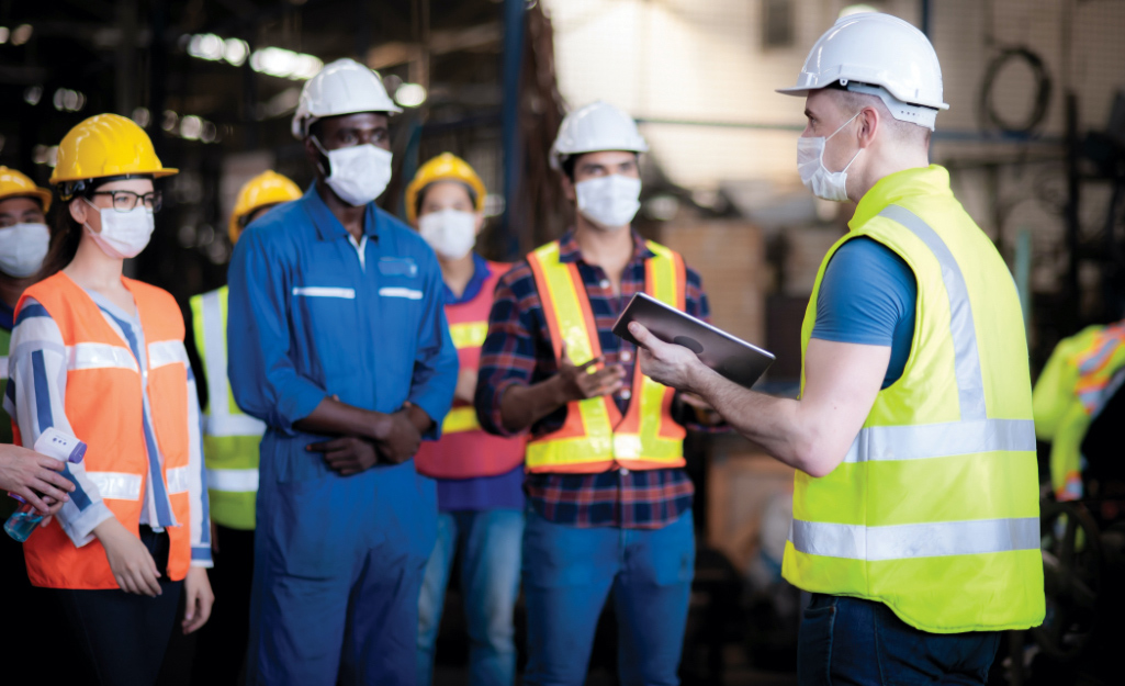 Employees have a jobsite safety meeting.