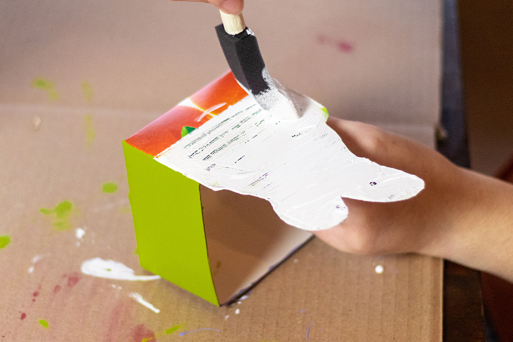 Person painting bunny cut out to carton
