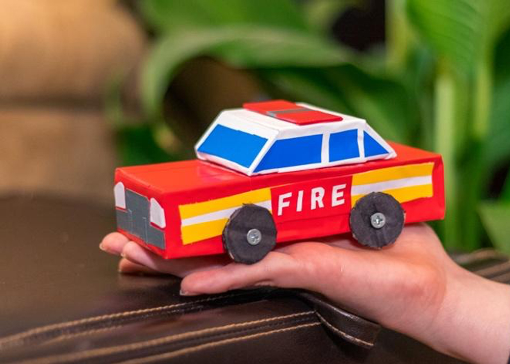 Small Fire Chief Car in child’s hand.