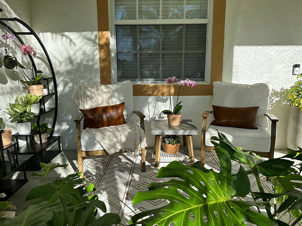 Front view of seating area surrounded by plants and a plant wall. Front view of seating area surrounded by plants and a plant wall.