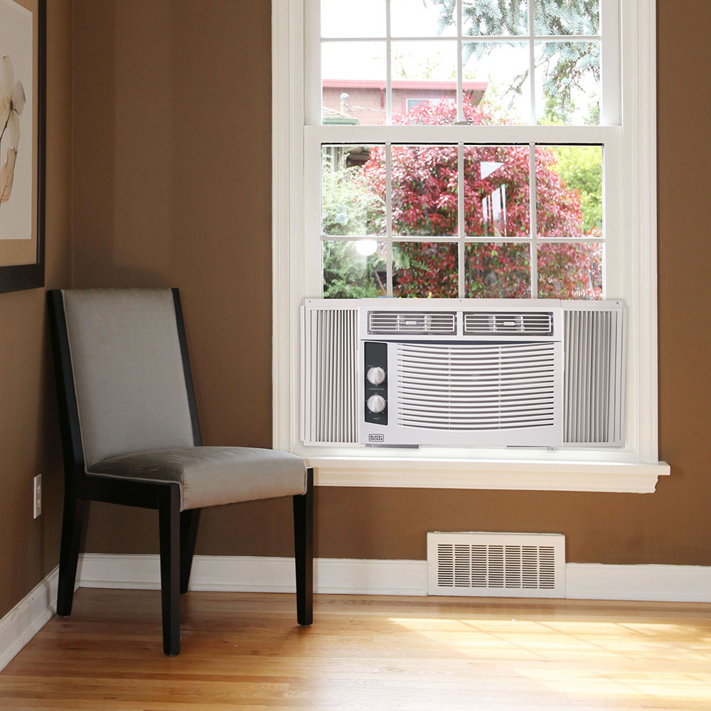 A window air conditioner cooling a room.