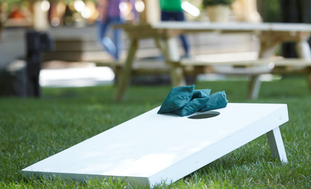 A corn hole game stands outdoors.