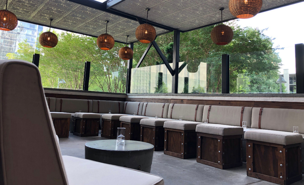 Outdoor furniture and light fixtures decorate a commercial patio.