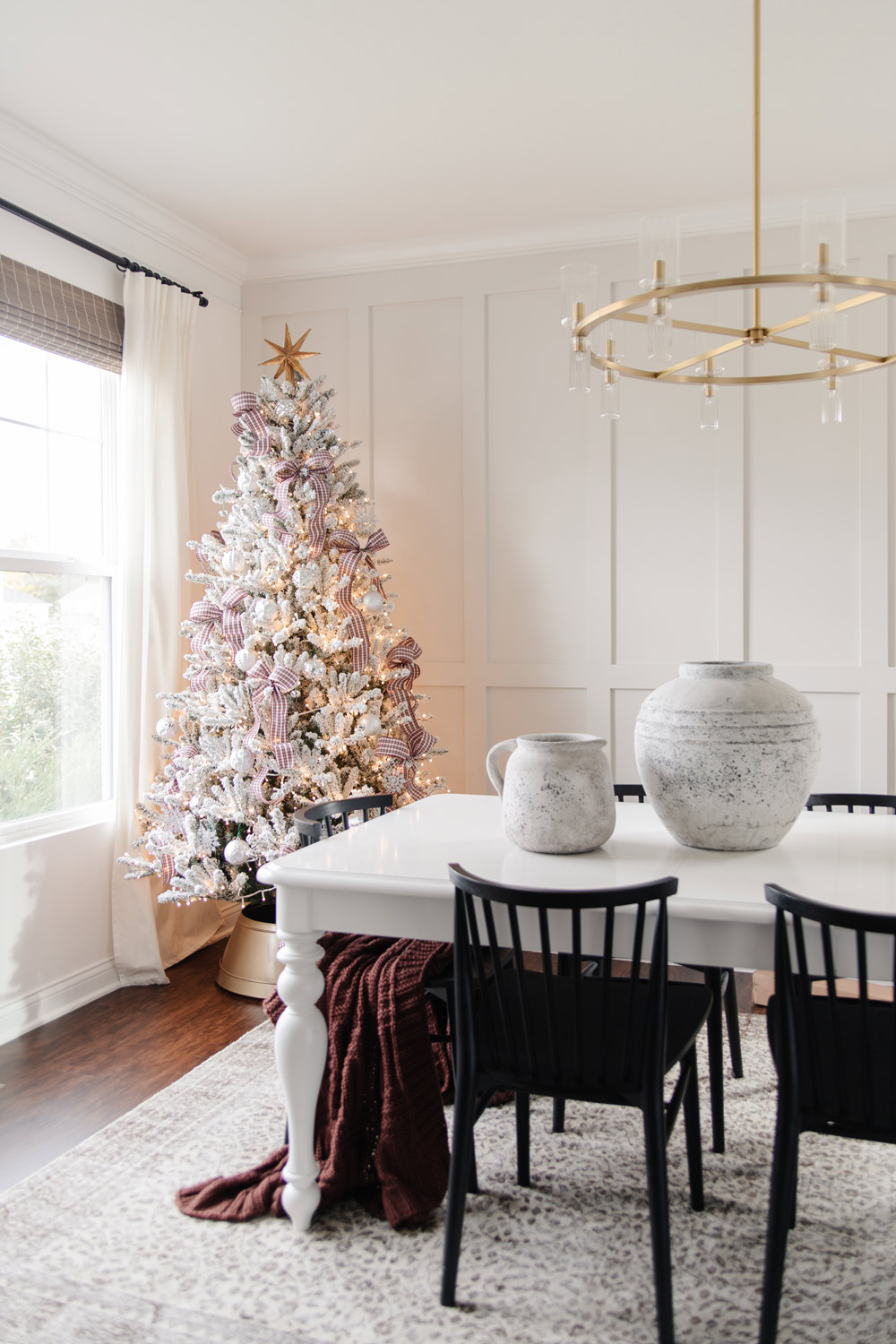 Dining room with a frocked Christmas tree. 
