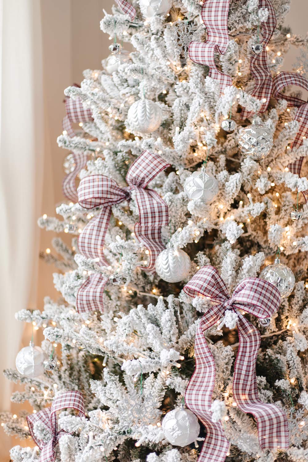 Frocked tree with ribbon bows and silver ornaments.