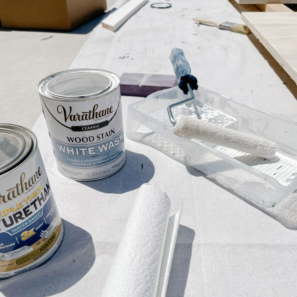 White wash wood stain, paint, and paint rollers. White wash wood stain, paint, and paint rollers.