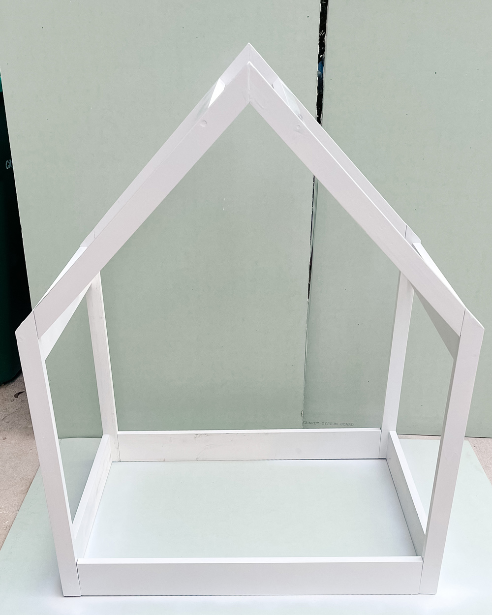 Wooden house frame painted white.