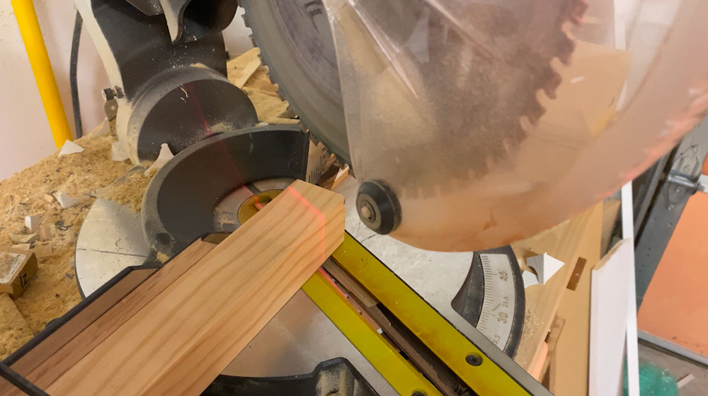 A circular saw lined up to cut a piece of wood.