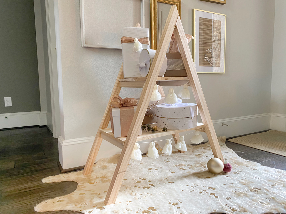 A completed DIY present ladder standing on a cowhide rug