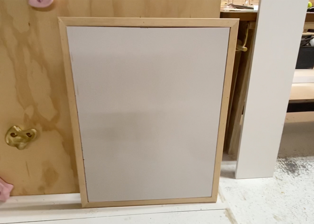 Whiteboard inside wood frame.