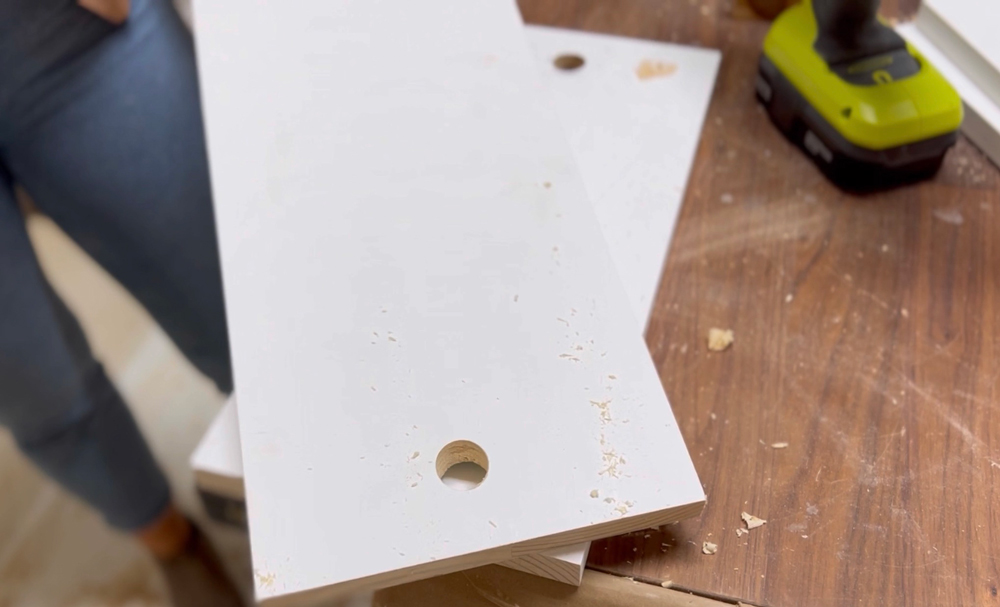 Two boards with holes drilled into wood.