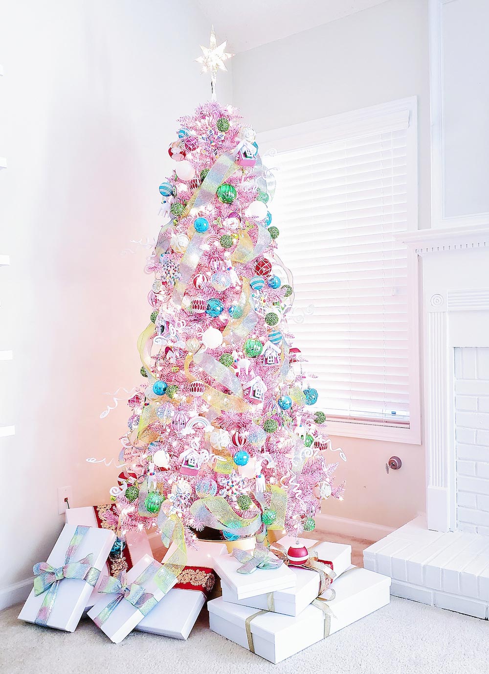 Tall colorful Christmas tree in the corner with gifts underneath