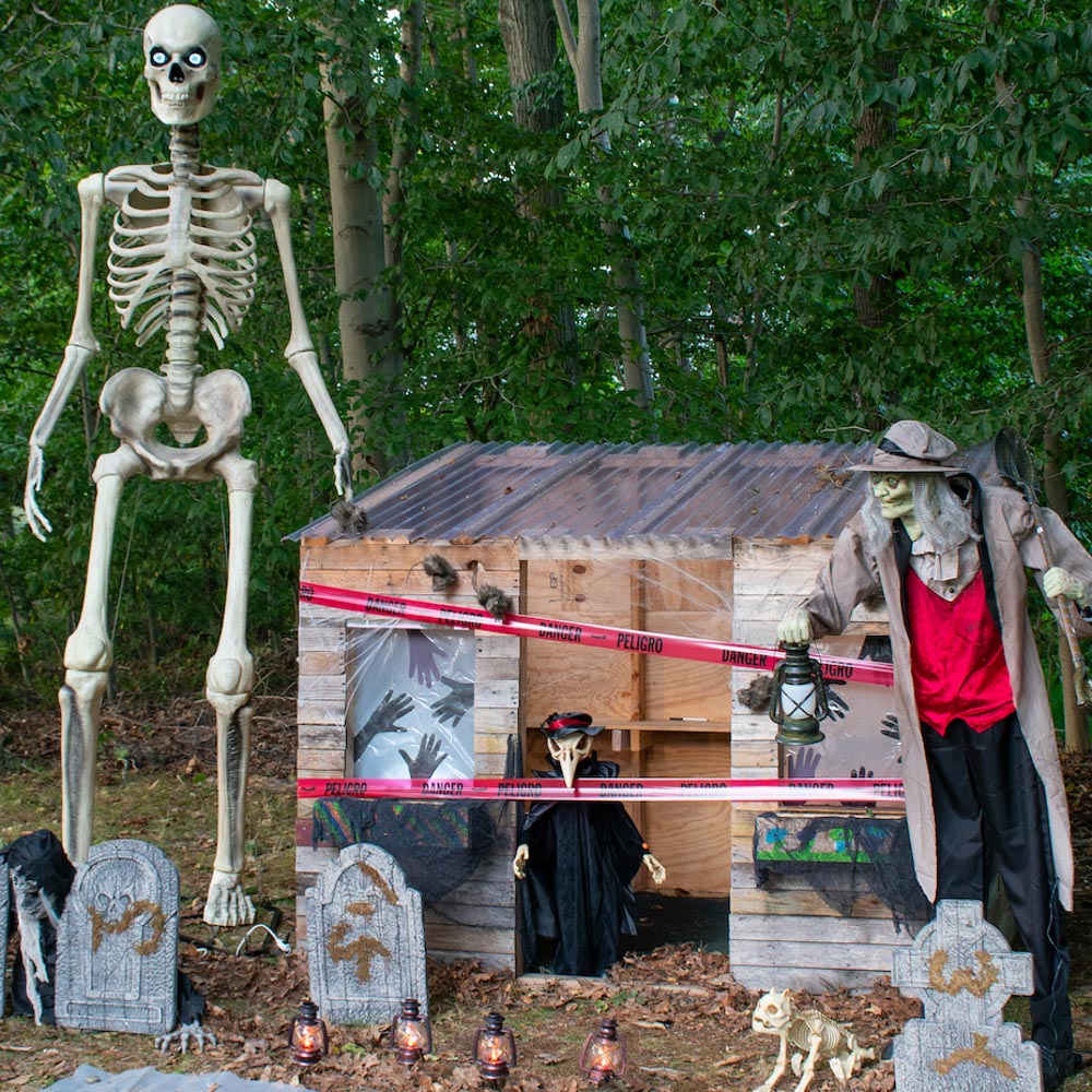 A wooden playhouse transformed into a graveyard for Halloween.