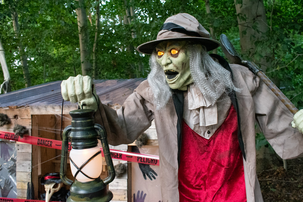 An animated gravedigger with glowing eyes and an open mouth.